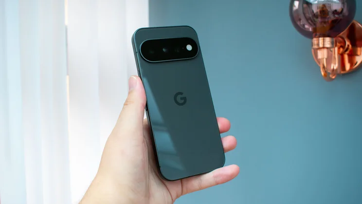 Google Pixel 11 in hand, rear view