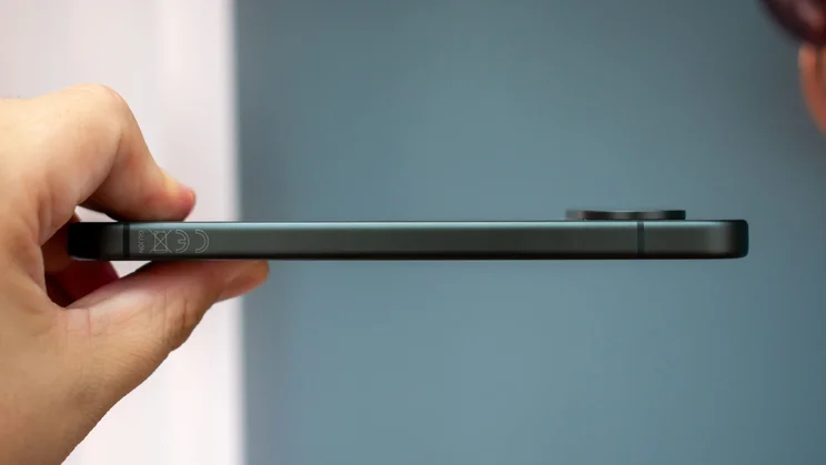 Google Pixel 11 in hand, side view