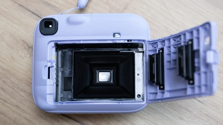A bird's eye view of the Instax Mini 13 instant camera's film compartment, open