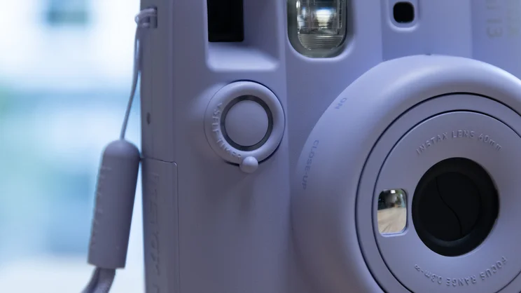 A closeup of the Instax Mini 13 instant camera's shutter button