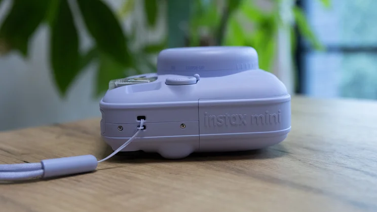 The Instax Mini 13 instant camera lying on its back on a table in an office