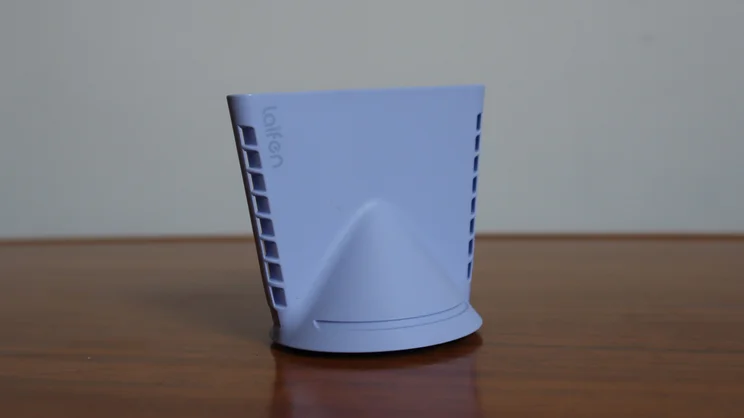 The Laifen Neo hair dryer's concentrator nozzle on a wooden table