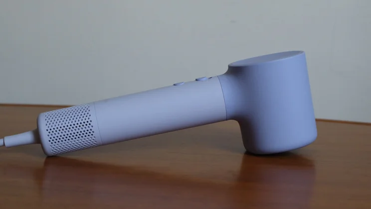 The Laifen Neo hair dryer lying on its front on a wooden table