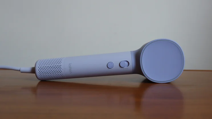The Laifen Neo hair dryer on its side on a wooden table