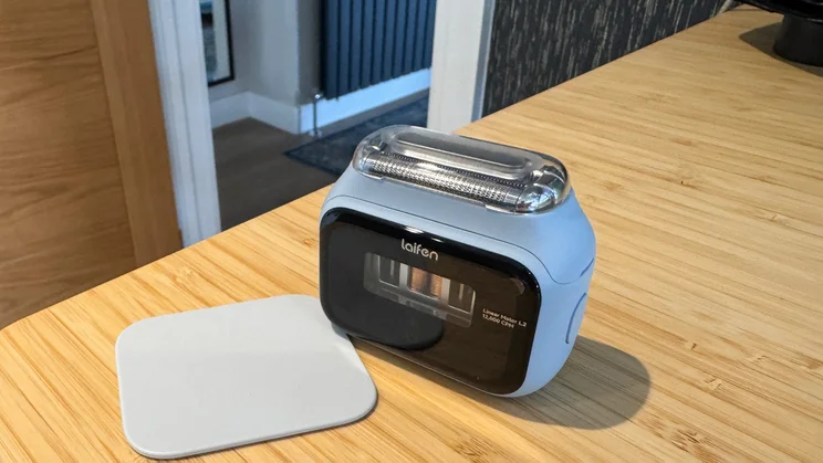 The Laifen P3 shaver alongside its non-slip pad, on a table