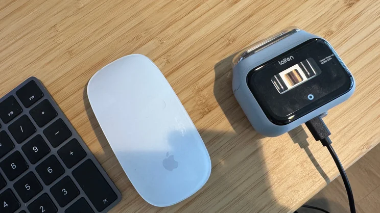 The Laifen P3 shaver, plugged in and charging, on a desk