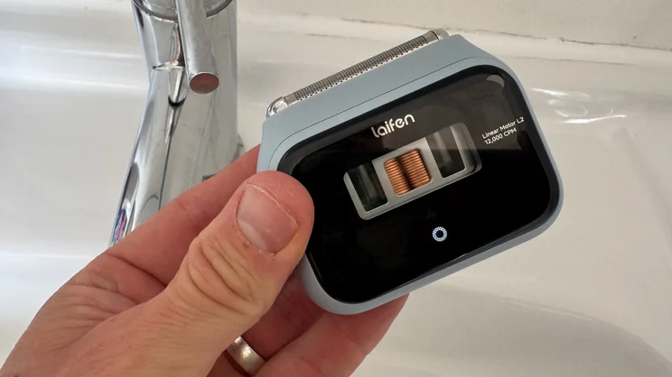 The Laifen P3 shaver in a hand, above a sink