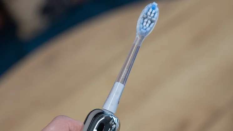 The Laifen Wave Pro electric toothbrush, with its Plaque Removal head attached, in a hand