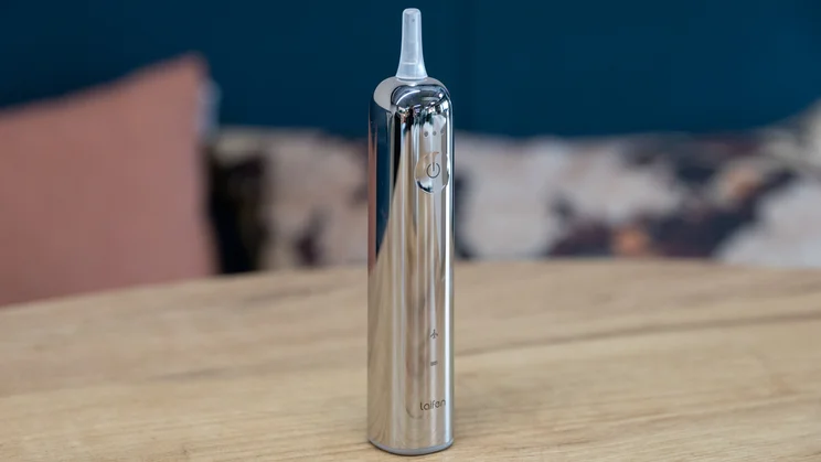 The Laifen Wave Pro electric toothbrush standing upright on a table, with no toothbrush head attached