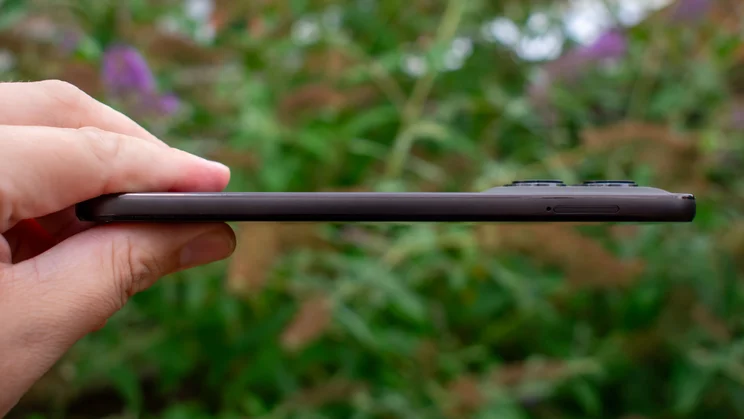 Motorola Moto G77 in hand, side view