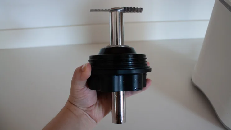 The Nutribullet Chill ice cream maker's blade removed, in a hand