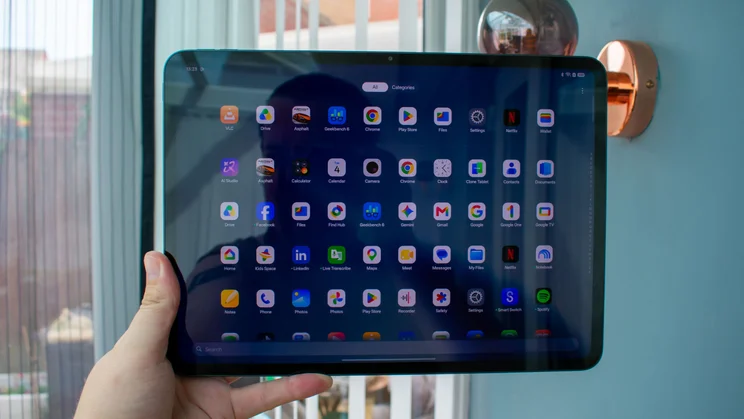 Oppo Pad 5 in hand, front view, displaying the app drawer
