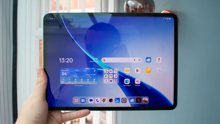 Oppo Pad 5 in hand, front view, displaying the homepage