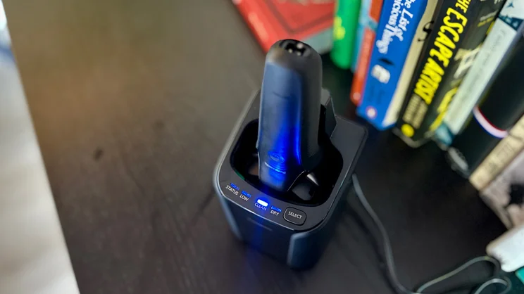 The Panasonic Series 900+ electric shaver in its cleaning dock