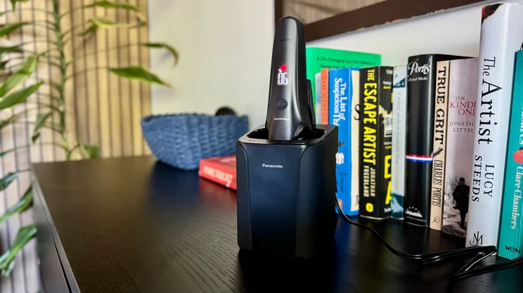 The Panasonic Series 900+ electric shaver in its cleaning dock