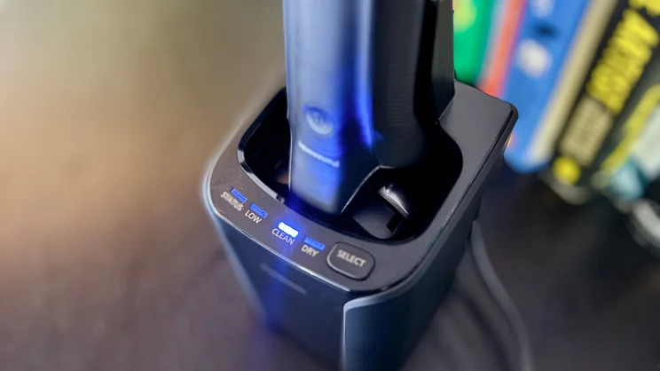A closeup of the Panasonic Series 900+ electric shaver in its cleaning dock