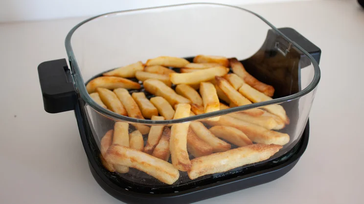 Cooked chips inside the Salter Crisp & Go air fryer's dish