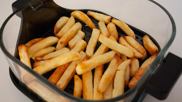 Cooked chips inside the Salter Crisp & Go air fryer's dish