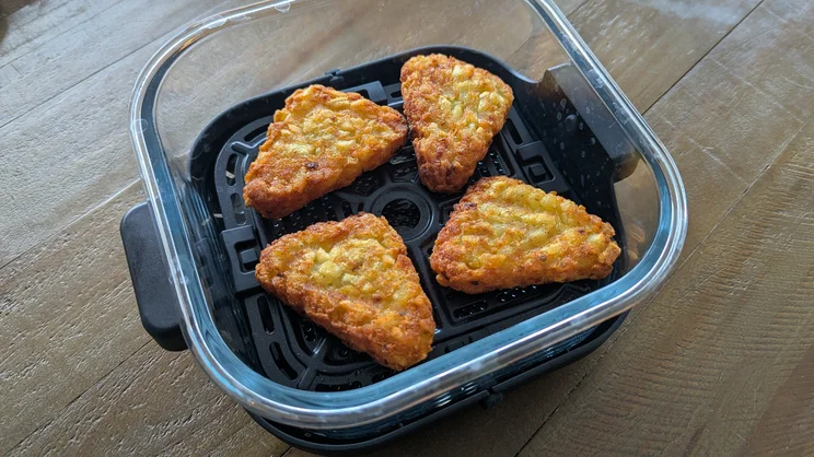 Cooked hash browns in the dish of the Salter Crisp & Go air fryer