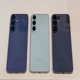Three Samsung Galaxy S26 FE smartphones in a row on a table