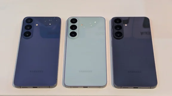 Three Samsung Galaxy S26 FE smartphones in a row on a table
