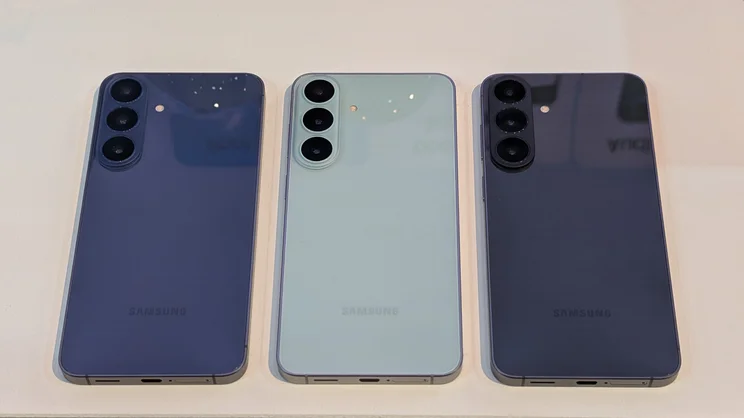 Three Samsung Galaxy S26 FE smartphones in a row on a table