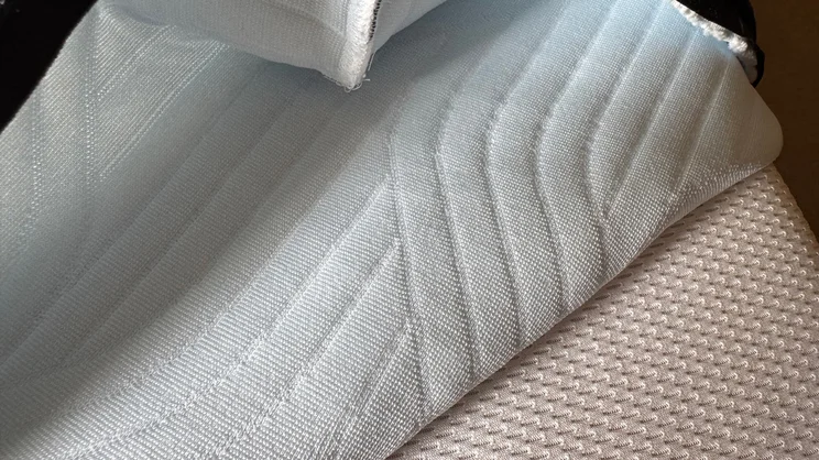 A closeup of the Tempur Pro Plus SmartCool mattress, its top cover partially removed