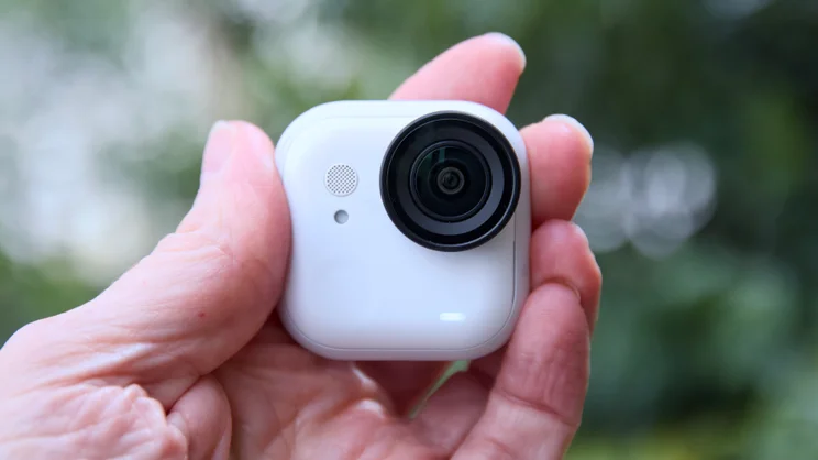 The Insta360 Go Ultra pictured being held in the fingertips