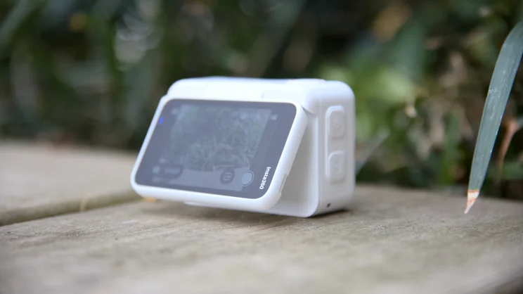 The Insta360 Go Ultra pictured from the rear with the articulating screen tilted slightly out