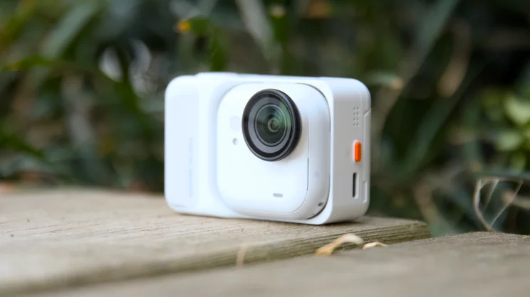 The Insta360 Go Ultra pictured in its dock from the front right quarter