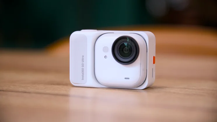The Insta360 Go Ultra pictured from the front on a wood surface
