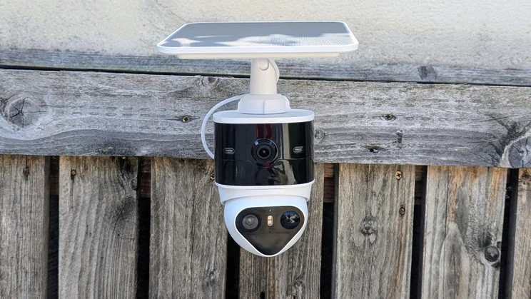 Front view of the Aosu Solarcam T2 Pro security camera attached to a wooden surface