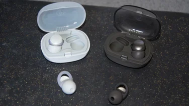 The Audio-Technica AT-ERP3 and AT-ERP5 earplugs with their carrying cases on a book