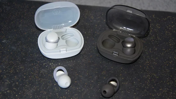 The Audio-Technica AT-ERP3 and AT-ERP5 earplugs with their carrying cases on a book