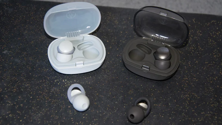 The Audio-Technica AT-ERP3 and AT-ERP5 earplugs with their carrying cases on a book