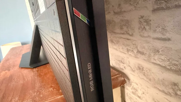 Side view of the Hisense UR9S RGB Mini LED TV showing the back section of the stand and the RGB Mini LED logo