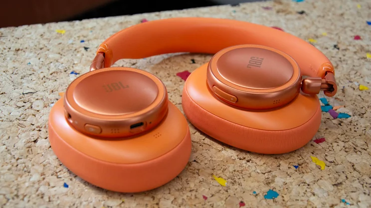 The JBL Live 780NC over-ear headphones with their earcups face down on a cork table