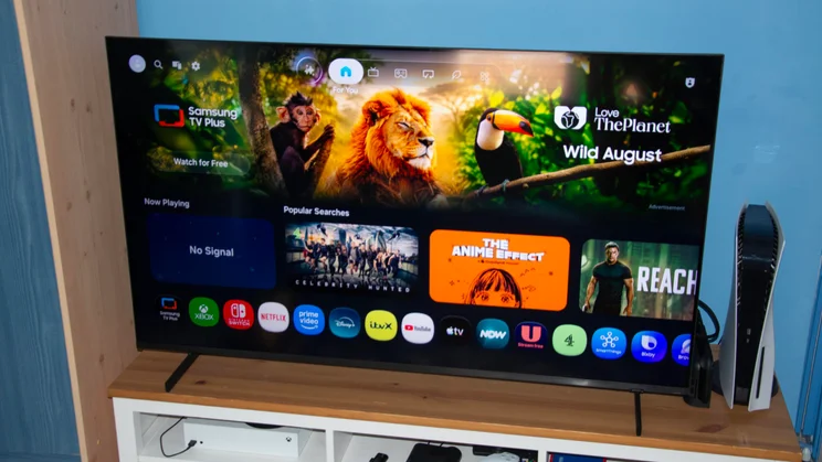 The Samsung QN80H Mini LED TV displaying the Tizen homepage with some reflection evident at the top of the screen