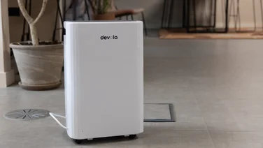 The Devola DVH12L Compressor dehumidifier on the floor of an office