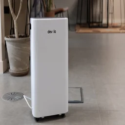 The Devola DVH12L Compressor dehumidifier on the floor of an office