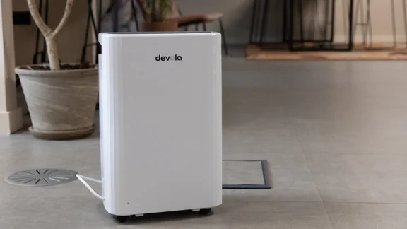 The Devola DVH12L Compressor dehumidifier on the floor of an office