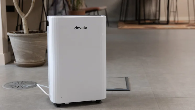 The Devola DVH12L Compressor dehumidifier on the floor of an office