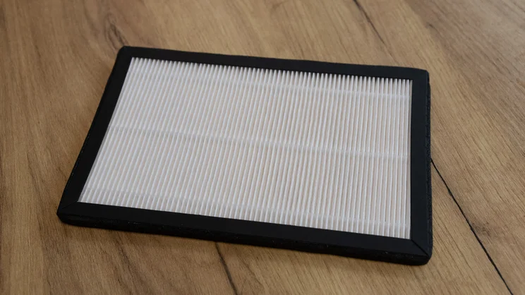 The Devola DVH12L Compressor dehumidifier's filter, removed and on a table