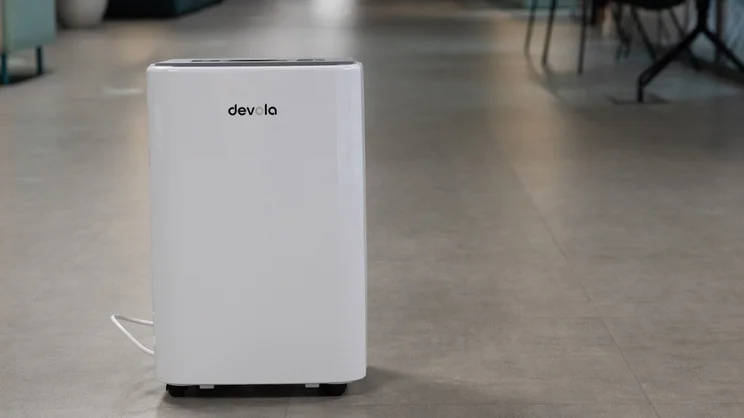 The Devola DVH12L Compressor dehumidifier on the floor of an office
