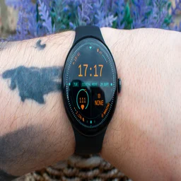 Google Pixel Watch 5 on wrist, displaying home screen