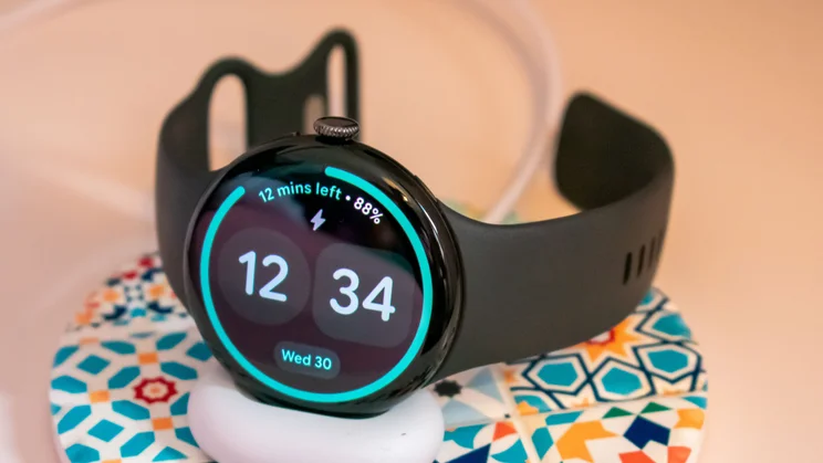 Google Pixel Watch 5 on the charging dock, bedside clock mode on the display