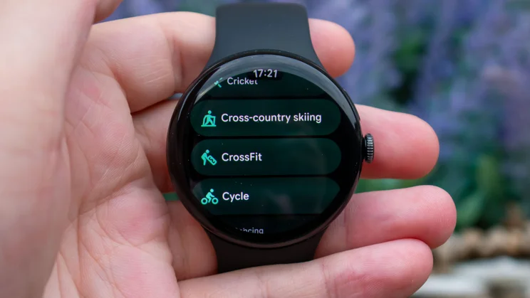 Google Pixel Watch 5 in hand, displaying workout options