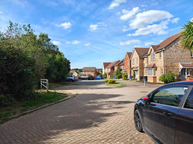 Quiet close of houses with cars parked around