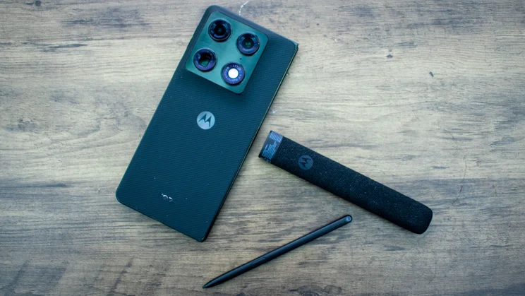 Motorola Razr Fold, Moto Pen Ultra and charging case arranged on a desk