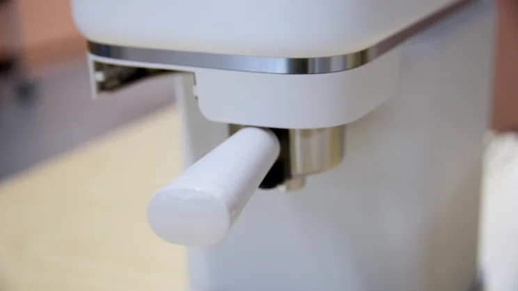 A close up of the Philips Baristina's brew group with portafilter in place before brewing